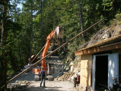 Big machines are essential on projects like this. Here the excavator lifts 2400 pounds of 8 inch steel pipe into place.