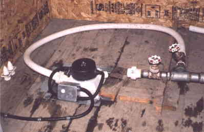 The turbine is mounted on the floor of the power shed. Discharge goes through to holding tank and drain back to creek