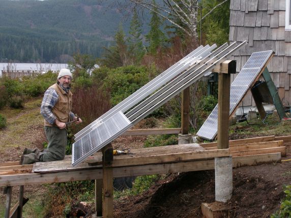 The owner assembling the aluminum rack. The original five modules shown in background.