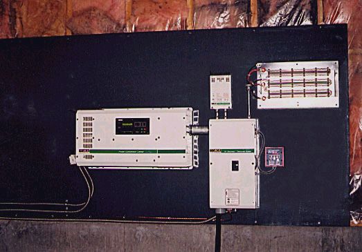 A Trace Engineering 4000 watt, 24 volt sine wave inverter and control panels.