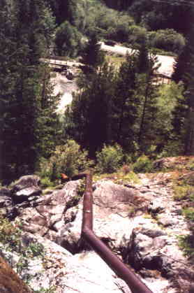 The 12 inch diameter penstock drops 100 feet to the turgo turbine.