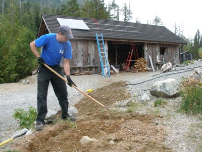 Paul Gallaway of Gallaway Electric in Ucluelet BC finishing trench for cable